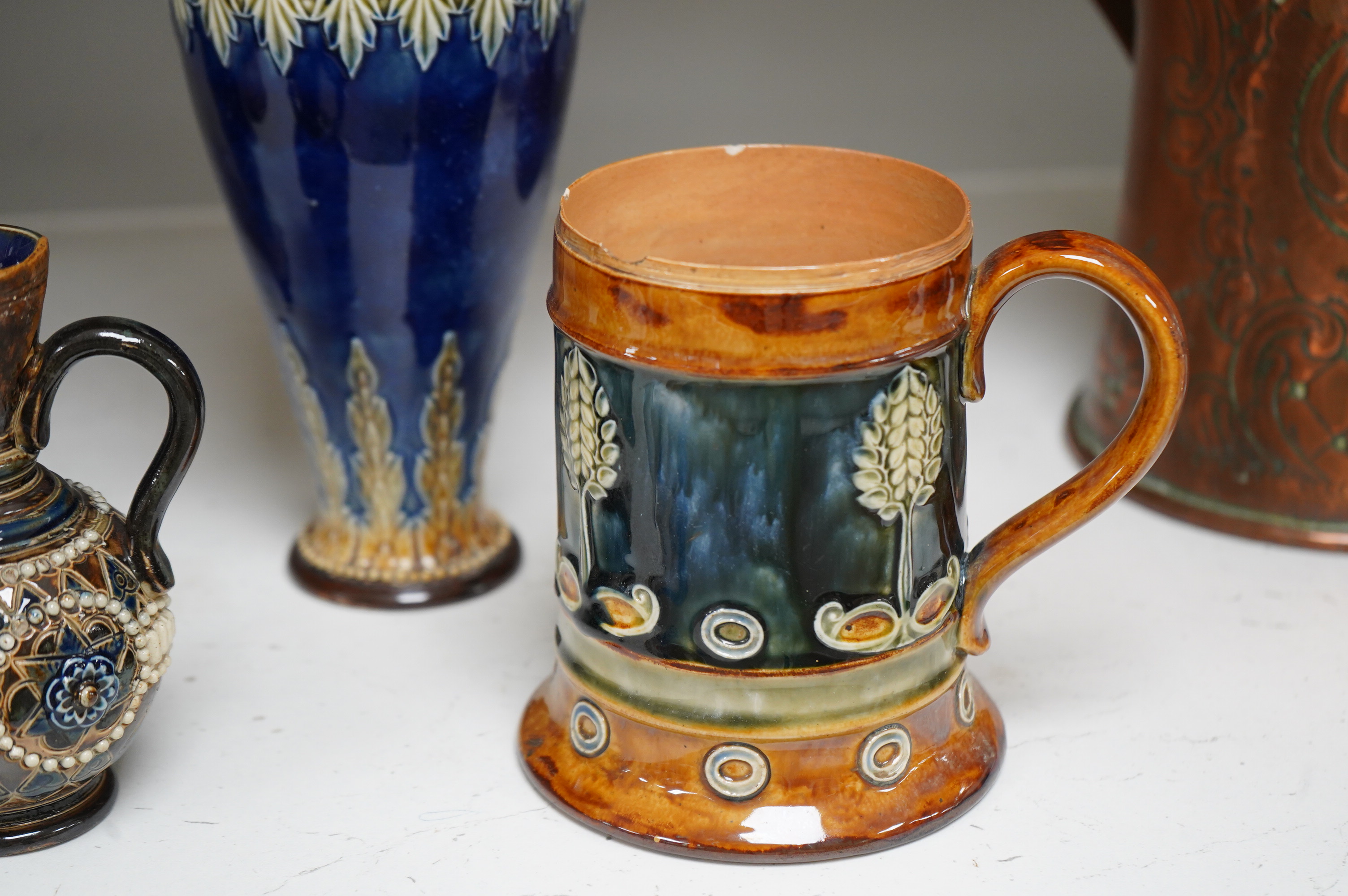 A Doulton Lambeth stoneware commemorative pitcher of William Ewart Gladstone 23cm high, together with a pair of vases two handled vase and a mug, (5).